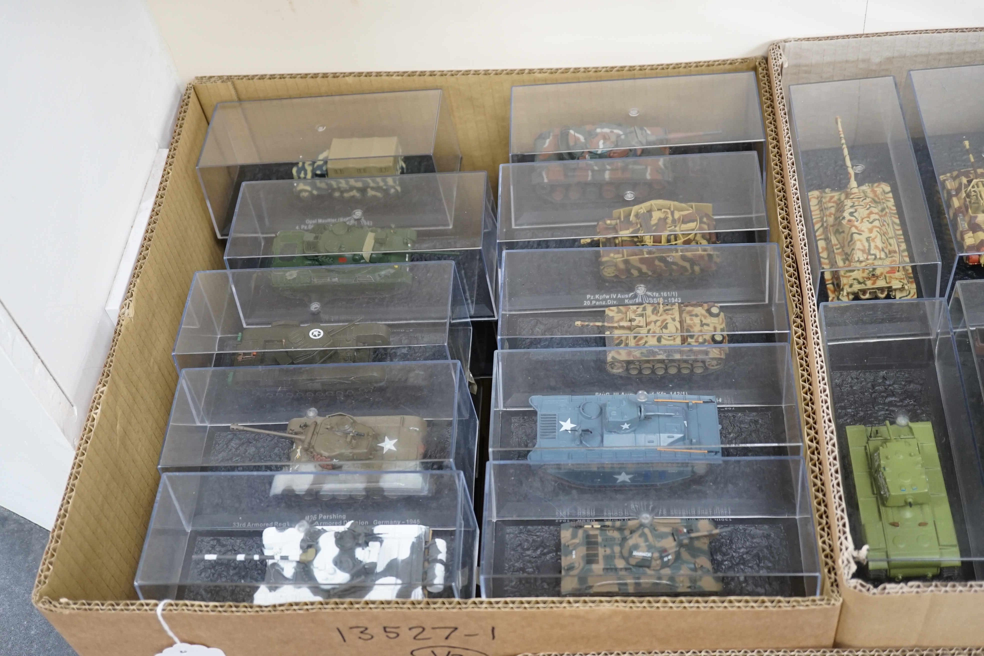 Sixty-eight magazine issue military vehicles in plastic display cases, including; tanks, armoured cars, personnel transporters, etc.